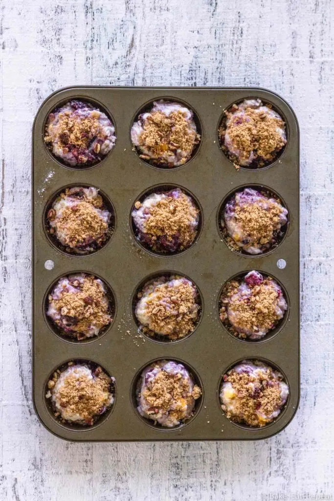 unbaked coffee cake muffins with peaches and blackberries