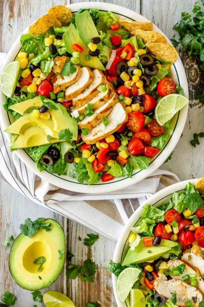 This chicken taco salad is one of our favourite meals - juicy, grilled cilantro lime chicken tossed with salad, tortilla chips and tasty taco ranch dressing!