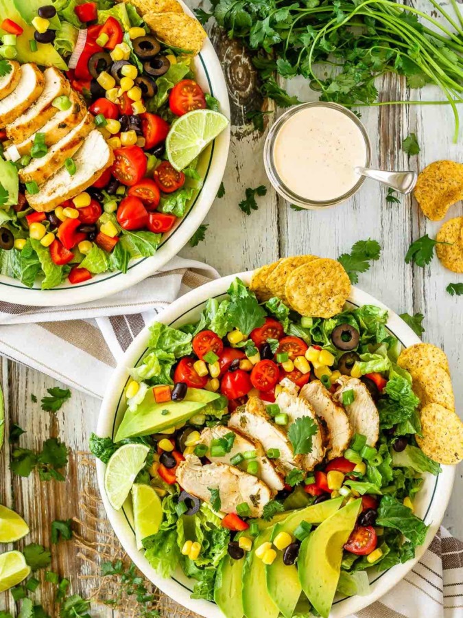 This chicken taco salad is one of our favourite meals - juicy, grilled cilantro lime chicken tossed with salad, tortilla chips and tasty taco ranch dressing!