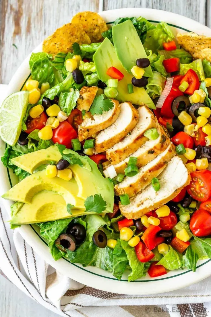 This chicken taco salad is one of our favourite meals - juicy, grilled cilantro lime chicken tossed with salad, tortilla chips and tasty taco ranch dressing!