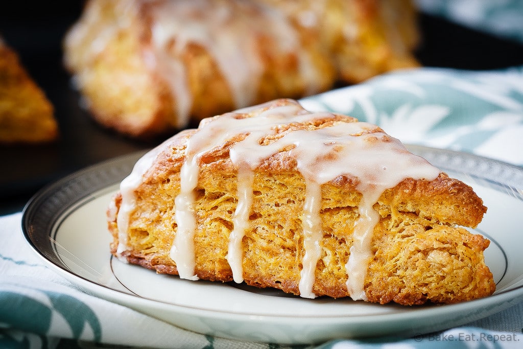 Pumpkin Scones - Light and fluffy pumpkin scones topped with a sweet maple glaze. These scones are the perfect breakfast treat to enjoy with your morning coffee!