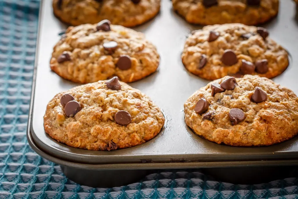 These chocolate chip banana oatmeal muffins are super easy to make. Filled with oats, whole wheat flour, and bananas - they're healthy enough for breakfast!