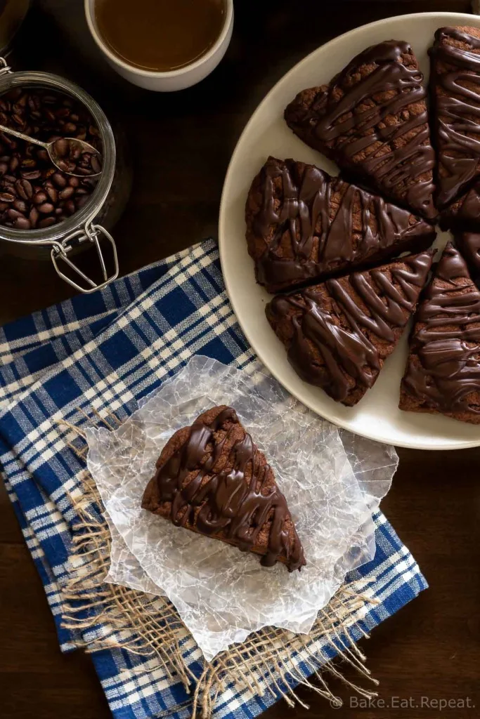 These double chocolate scones are easy to make and are decadent enough to be dessert, but since they're scones you can probably justify having them for breakfast! Buttery and flaky chocolate scones, filled with chocolate chips, and topped with a chocolate glaze - in short, they're amazing.