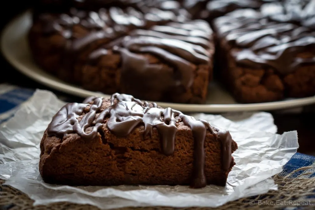 These double chocolate scones are easy to make and are decadent enough to be dessert, but since they're scones you can probably justify having them for breakfast! Buttery and flaky chocolate scones, filled with chocolate chips, and topped with a chocolate glaze - in short, they're amazing.