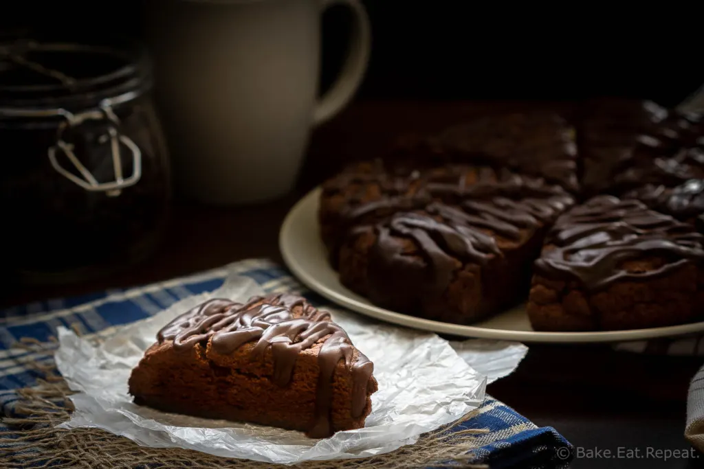 These double chocolate scones are easy to make and are decadent enough to be dessert, but since they're scones you can probably justify having them for breakfast! Buttery and flaky chocolate scones, filled with chocolate chips, and topped with a chocolate glaze - in short, they're amazing.