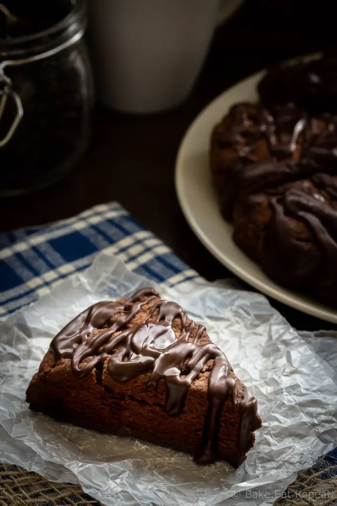 These double chocolate scones are easy to make and are decadent enough to be dessert, but since they're scones you can probably justify having them for breakfast! Buttery and flaky chocolate scones, filled with chocolate chips, and topped with a chocolate glaze - in short, they're amazing.