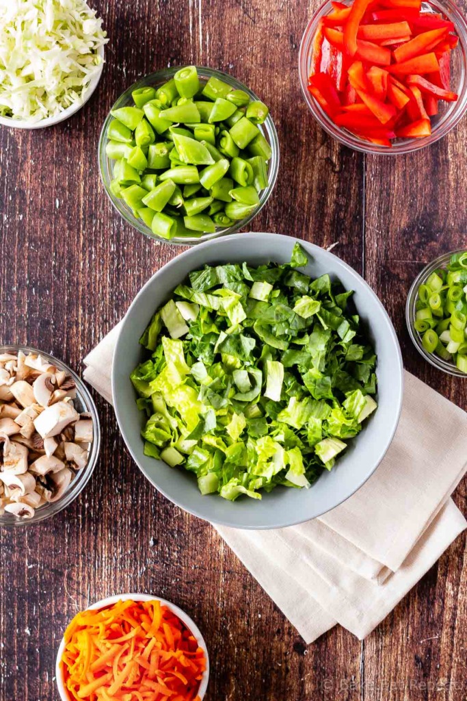 Chopped lettuce, snap peas, red peppers, green onions, cabbage, mushrooms and carrots for salad