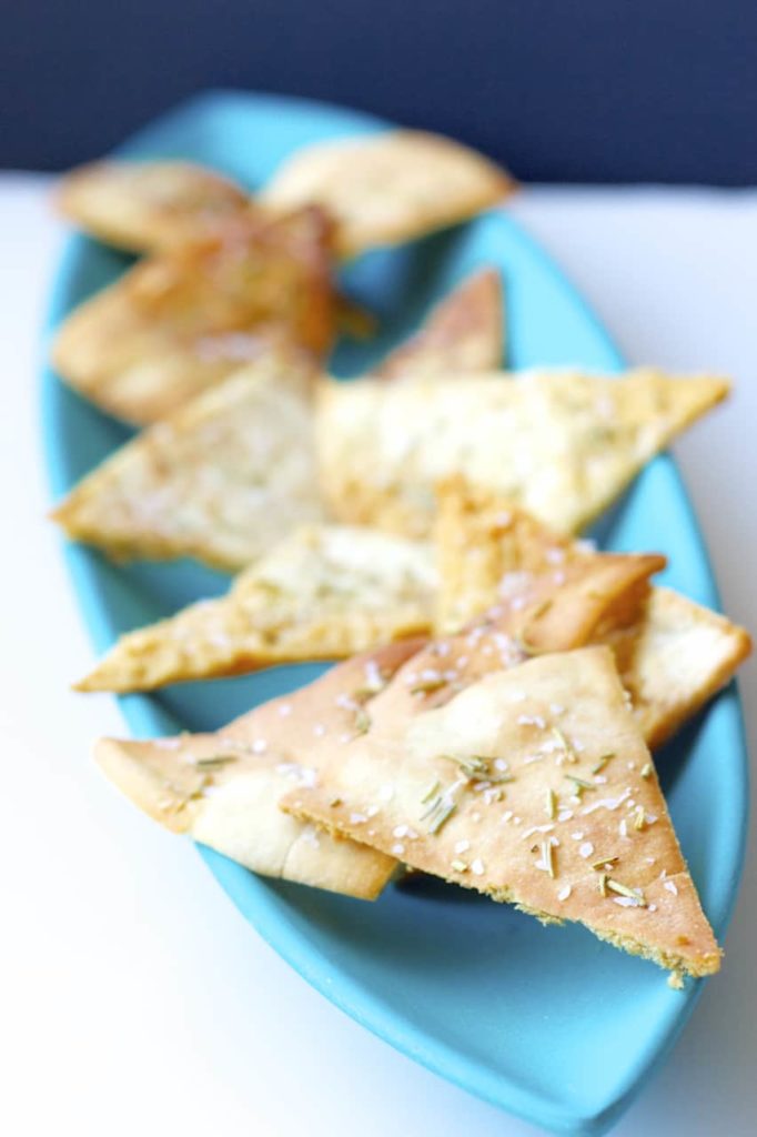 These homemade pita chips are seasoned with salt and rosemary and baked to crispy perfection. An easy snack to make at home!