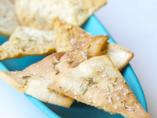 These homemade baked rosemary pita chips are seasoned with salt and rosemary and baked to crispy perfection. An easy snack to make at home!