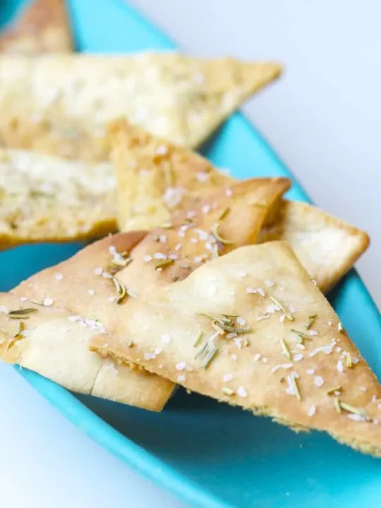 These homemade baked rosemary pita chips are seasoned with salt and rosemary and baked to crispy perfection. An easy snack to make at home!
