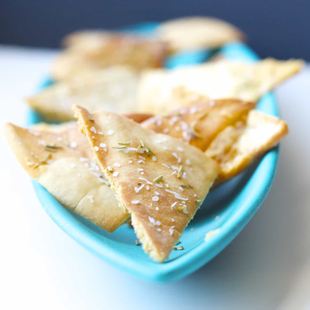 These homemade pita chips are seasoned with salt and rosemary and baked to crispy perfection. An easy snack to make at home!