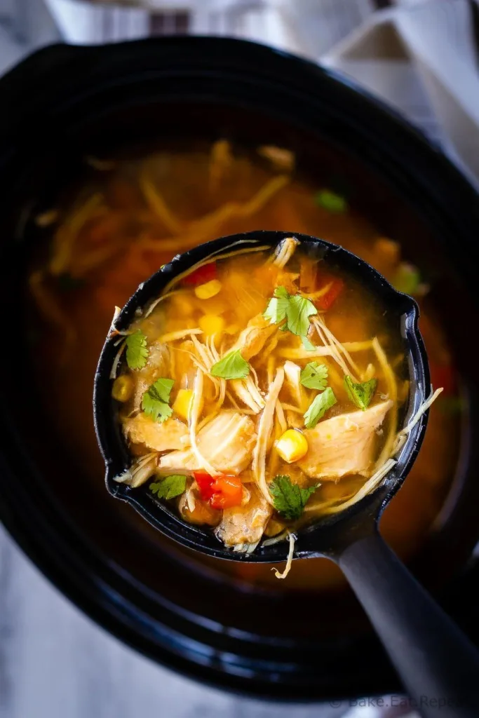 Slow cooker chicken taco soup - the easiest soup to toss in the slow cooker in the morning, and so full of flavour. The whole family will love it!