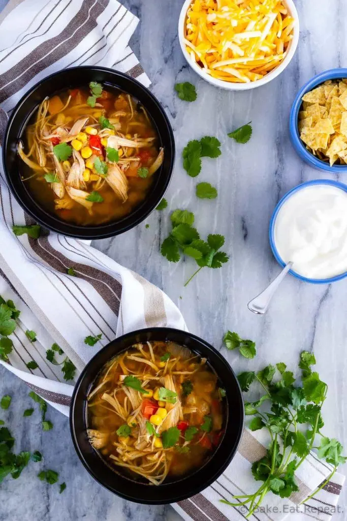 Slow cooker chicken taco soup - the easiest soup to toss in the slow cooker in the morning, and so full of flavour. The whole family will love it!