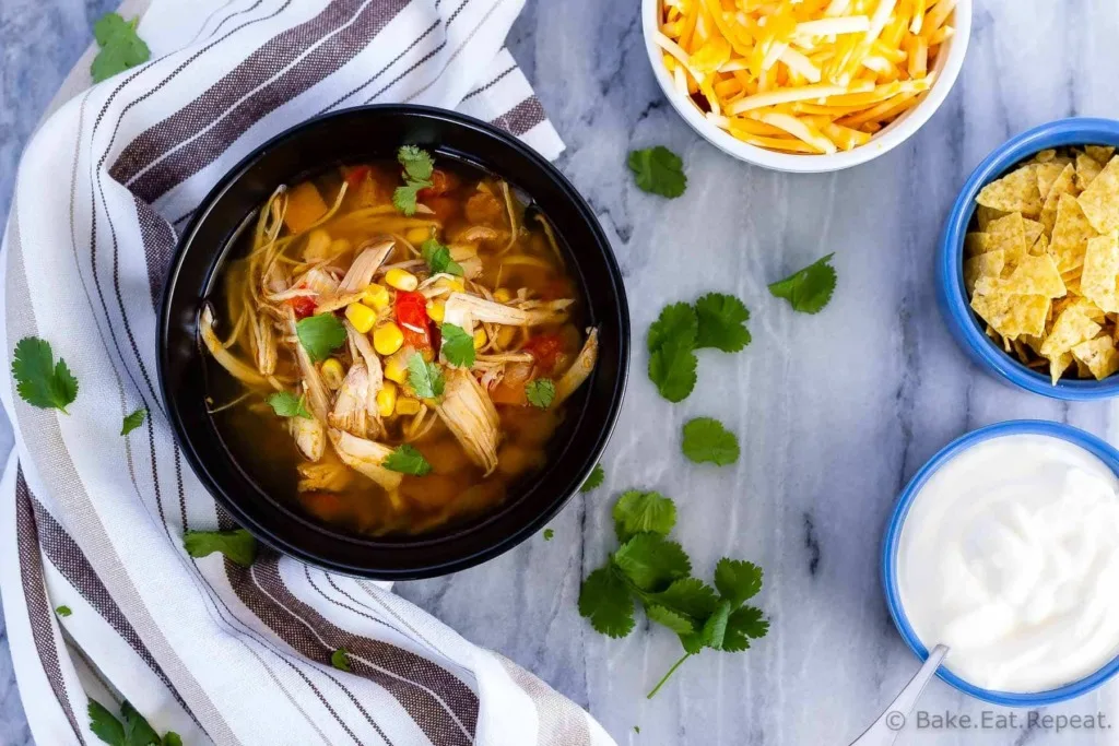 Slow cooker chicken taco soup - the easiest soup to toss in the slow cooker in the morning, and so full of flavour. The whole family will love it!