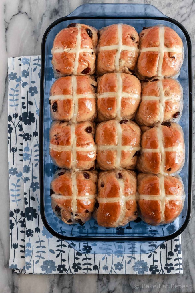 Soft and fluffy hot cross buns filled with raisins and topped with a honey lemon glaze - they make the perfect treat for the Easter season!