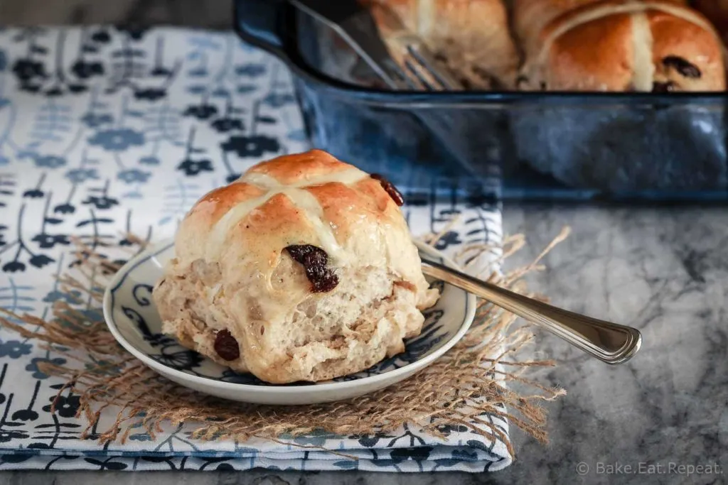 Soft and fluffy hot cross buns filled with raisins and topped with a honey lemon glaze - they make the perfect treat for the Easter season!