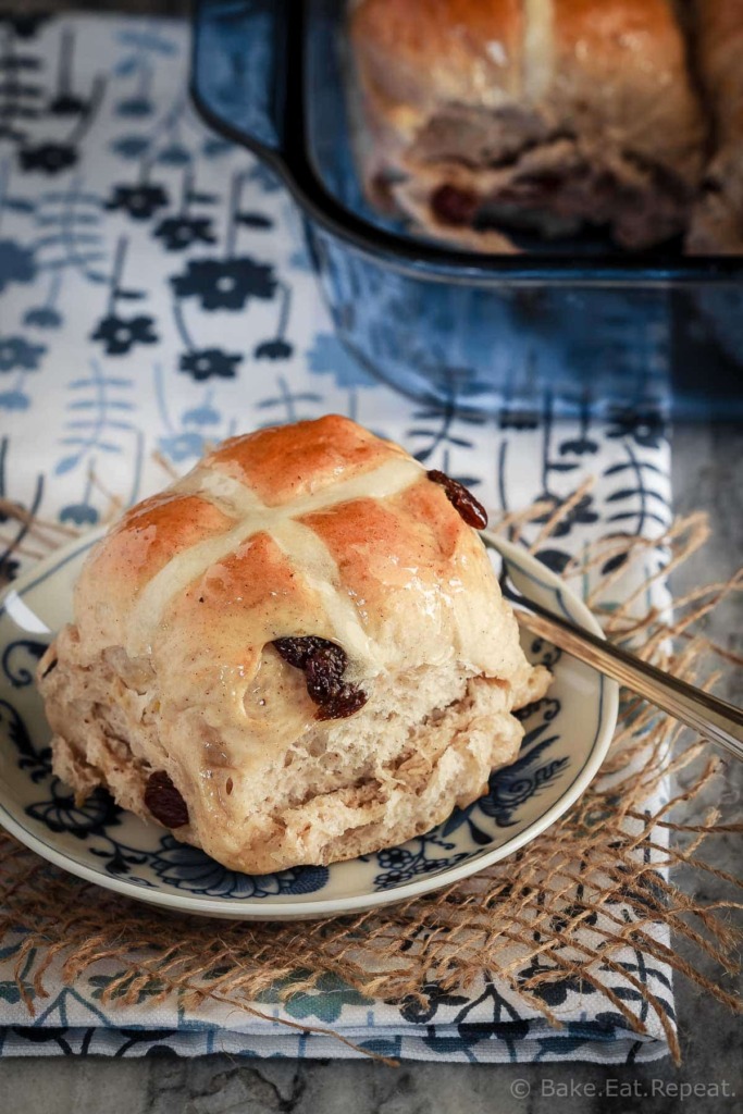 Soft and fluffy hot cross buns filled with raisins and topped with a honey lemon glaze - they make the perfect treat for the Easter season!