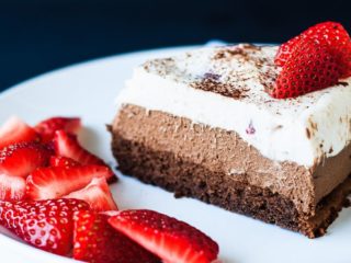 Chocolate Mousse Cake - A decadent triple chocolate strawberry mousse cake that is perfect for a special occasion. Flourless chocolate cake, dark chocolate mousse, and a white chocolate strawberry mousse - a chocolate lover's dream!