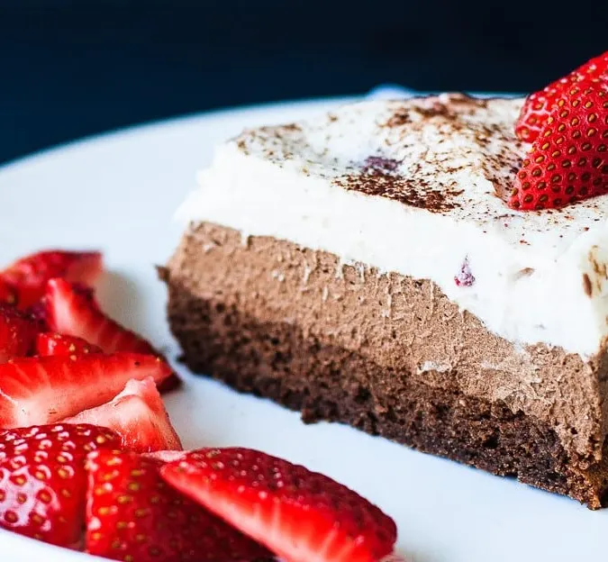 Chocolate Mousse Cake - A decadent triple chocolate strawberry mousse cake that is perfect for a special occasion. Flourless chocolate cake, dark chocolate mousse, and a white chocolate strawberry mousse - a chocolate lover's dream!