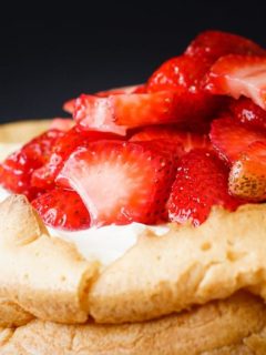 Lemon Strawberry Cream Puff Cake - An amazing lemon strawberry cream puff cake that is absolutely stunning. A giant cream puff shell filled with lemon curd, then a creamy whipped filling and topped with fresh strawberries. This dessert will not last long!