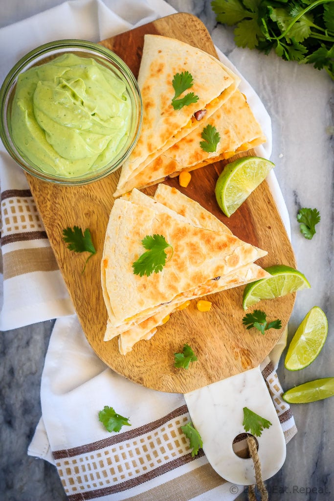 Shrimp quesadillas filled with corn, black beans and cheese, and an avocado cilantro lime cream dipping sauce. Quick and easy and everyone loves them!