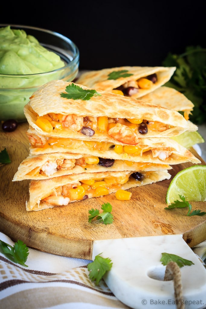 Shrimp quesadillas filled with corn, black beans and cheese, and an avocado cilantro lime cream dipping sauce. Quick and easy and everyone loves them!