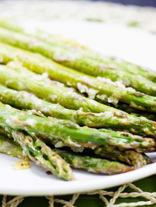 Lemon Roasted Asparagus - This quick and easy roasted lemon parmesan asparagus is the perfect way to brighten up this tasty spring vegetable! Plus, it only takes 15 minutes to get on the table!