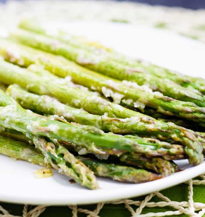 Lemon Roasted Asparagus - This quick and easy roasted lemon parmesan asparagus is the perfect way to brighten up this tasty spring vegetable! Plus, it only takes 15 minutes to get on the table!