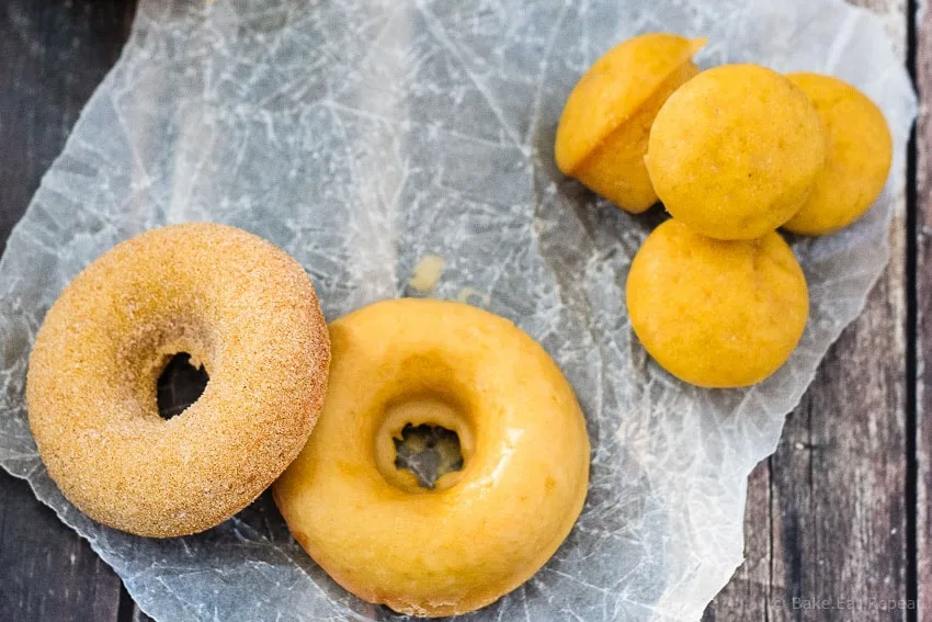 Baked Pumpkin Spice Doughnuts - Quick and easy baked pumpkin spice doughnuts (or doughnut holes!) coated with either a sweet maple glaze or cinnamon sugar. Either way - they're absolutely amazing!