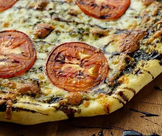 Caprese Pizza - Easy caprese pizza with pesto, mozzarella and tomatoes, and drizzled with balsamic glaze.