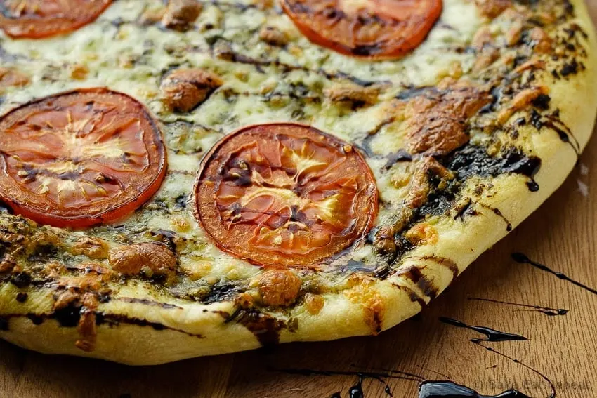 Caprese Pizza - Easy caprese pizza with pesto, mozzarella and tomatoes, and drizzled with balsamic glaze. 