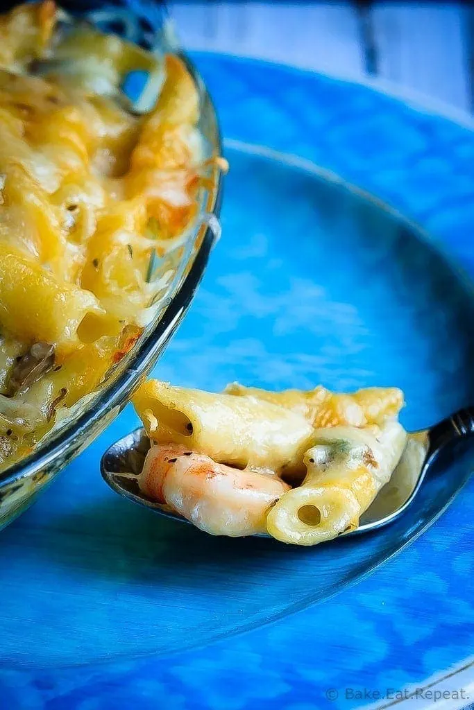 Baked Shrimp Pasta with Mushroom Alfredo Sauce - Cheesy baked pasta with a clam and mushroom alfredo sauce - cheesy comfort food at it's best! You will make this pasta again and again!