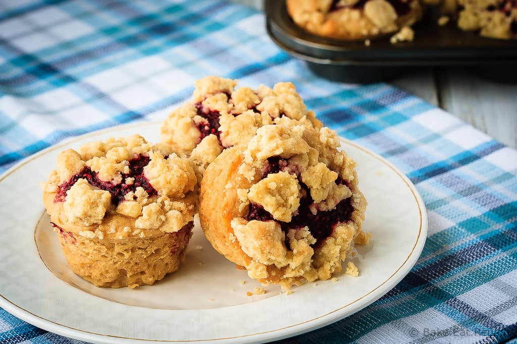 Peanut Butter and Jelly Muffins - Amazing peanut butter and jelly muffins - light and fluffy peanut butter muffins with a homemade raspberry jam filling and a buttery crumb topping!