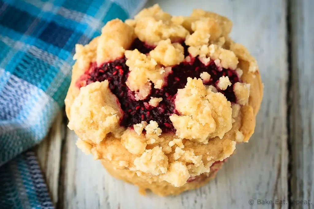 Peanut Butter and Jelly Muffins - Amazing peanut butter and jelly muffins - light and fluffy peanut butter muffins with a homemade raspberry jam filling and a buttery crumb topping!