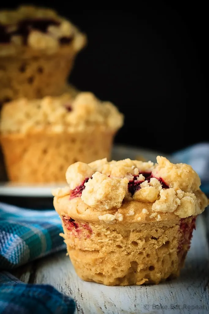 Peanut Butter and Jelly Muffins - Amazing peanut butter and jelly muffins - light and fluffy peanut butter muffins with a homemade raspberry jam filling and a buttery crumb topping!