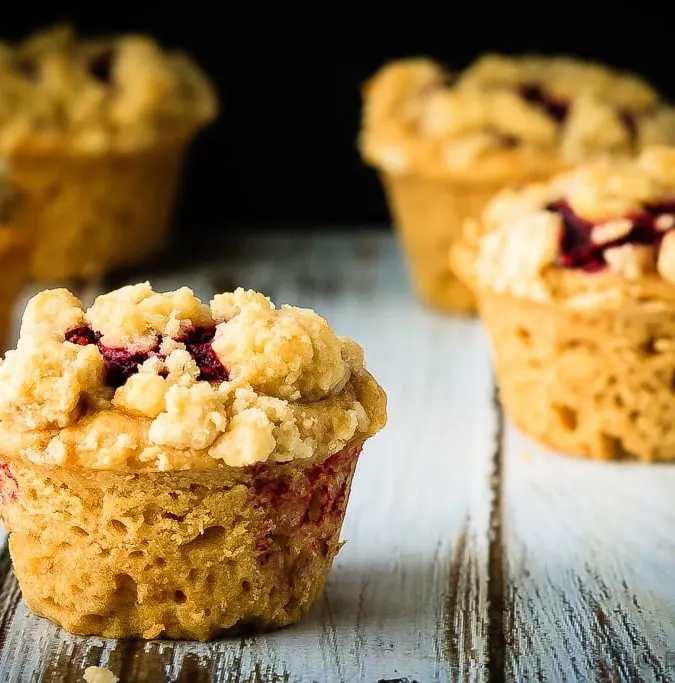 Peanut Butter and Jelly Muffins - Amazing peanut butter and jelly muffins - light and fluffy peanut butter muffins with a homemade raspberry jam filling and a buttery crumb topping!