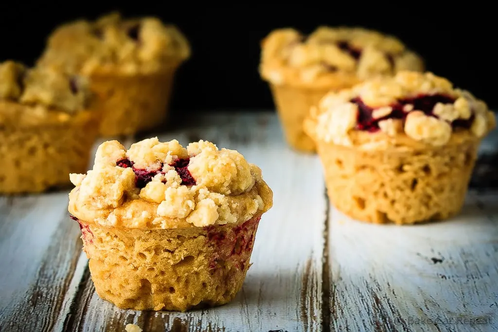Peanut Butter and Jelly Muffins - Amazing peanut butter and jelly muffins - light and fluffy peanut butter muffins with a homemade raspberry jam filling and a buttery crumb topping!