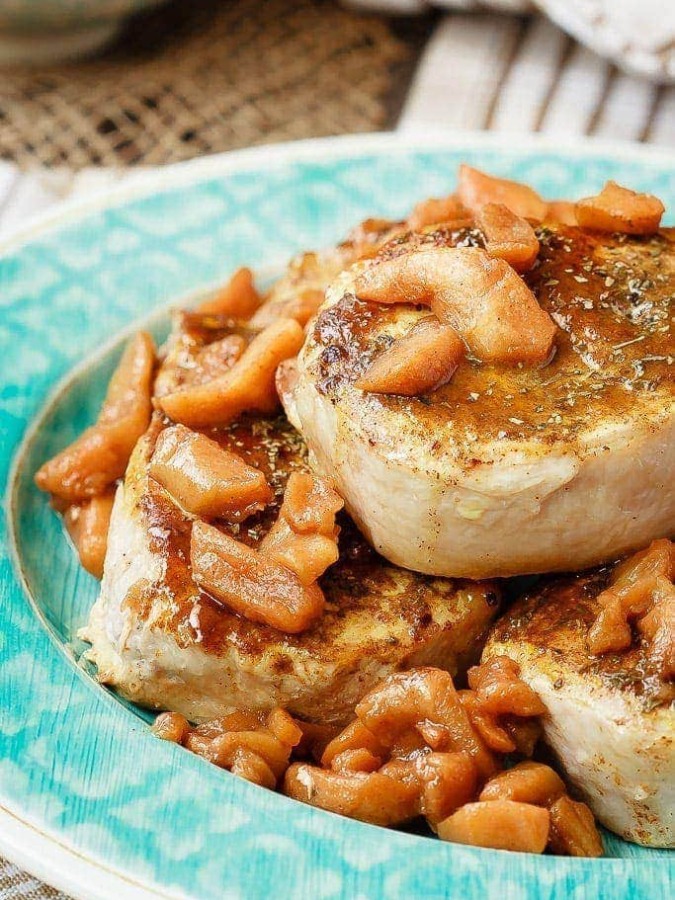 Baked Pork Chops with a Cinnamon Glaze - These baked pork chops with a cinnamon glaze are a simple, 30 minute meal that your whole family will love. Served with baked cinnamon apples and so tasty!