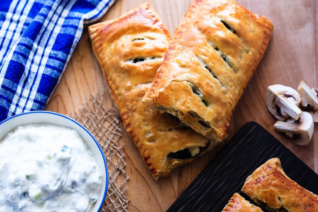 Beef Spinach and Mushroom Strudel - An easy appetizer made with puff pastry that everyone will love - this savoury strudel is filled with ground beef, mushrooms, spinach and feta cheese and served with tzatziki dip.