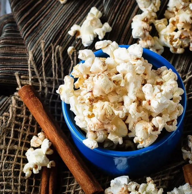 Cinnamon Roll Popcorn - A great way to change up the usual movie night snack, this cinnamon roll popcorn is a wonderful sweet and salty snack that everyone will love!