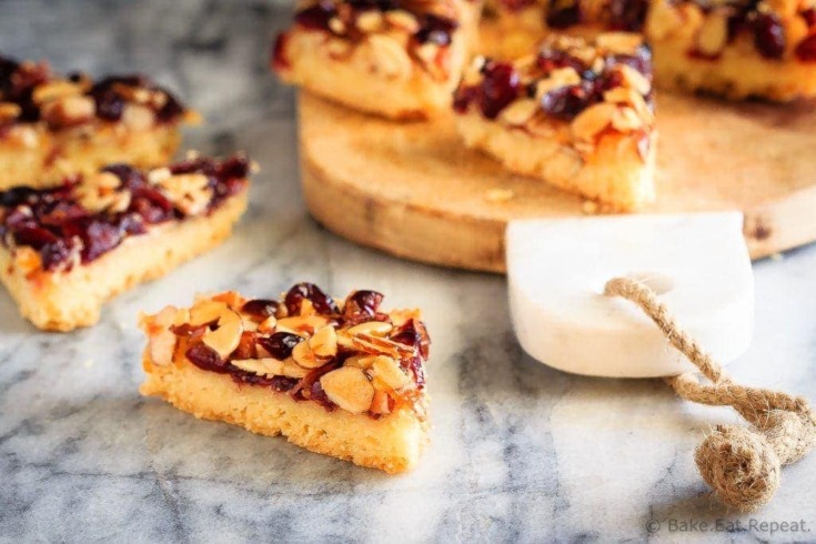 Glazed Cranberry Almond Bars - These glazed cranberry almond bars are the perfect addition to your Christmas cookie tray. Pretty, festive, and so easy to make, everyone will love them!