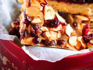 Glazed Cranberry Almond Bars - These glazed cranberry almond bars are the perfect addition to your Christmas cookie tray. Pretty, festive, and so easy to make, everyone will love them!