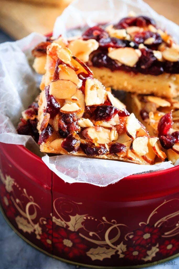 Glazed Cranberry Almond Bars - These glazed cranberry almond bars are the perfect addition to your Christmas cookie tray. Pretty, festive, and so easy to make, everyone will love them!