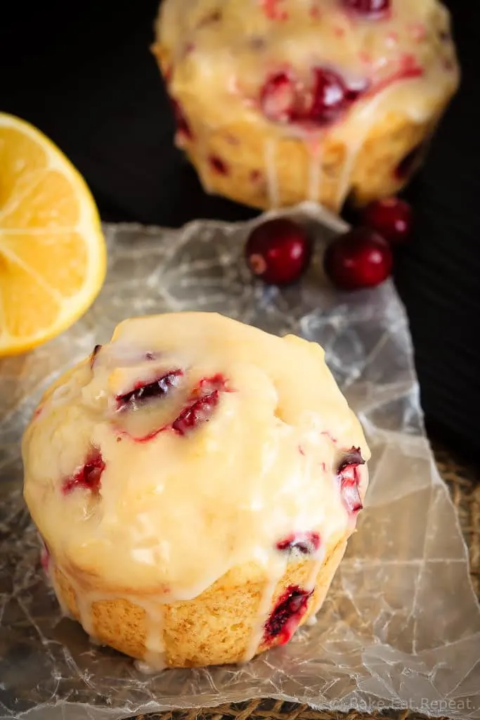 Glazed Lemon Cranberry Muffins - These glazed lemon cranberry muffins are light and fluffy with the tart, fresh cranberries complimenting the sweet lemon glaze perfectly!