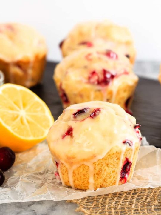 Glazed Lemon Cranberry Muffins - These glazed lemon cranberry muffins are light and fluffy with the tart, fresh cranberries complimenting the sweet lemon glaze perfectly!