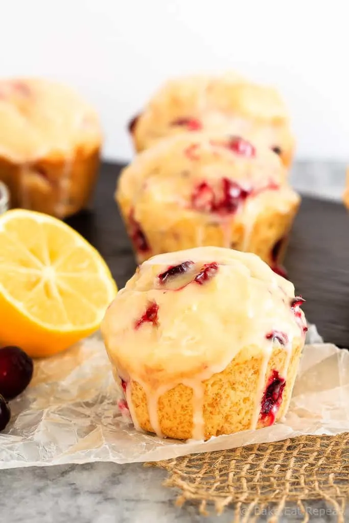 Glazed Lemon Cranberry Muffins - These glazed lemon cranberry muffins are light and fluffy with the tart, fresh cranberries complimenting the sweet lemon glaze perfectly!