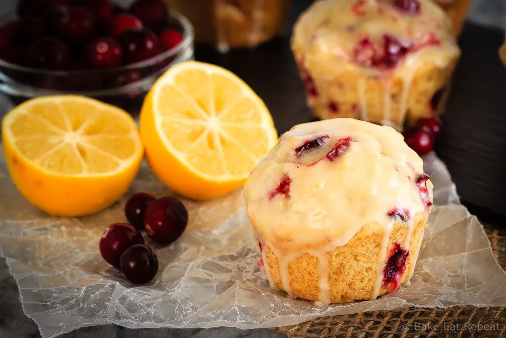 Glazed Lemon Cranberry Muffins - These glazed lemon cranberry muffins are light and fluffy with the tart, fresh cranberries complimenting the sweet lemon glaze perfectly!