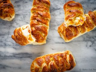 These braided ham, egg and cheese pretzel rolls are the perfect hand held meal. Plus they're easy to take along with you for breakfast or lunch on the go!