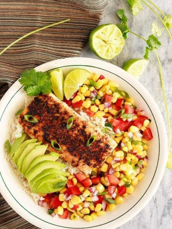 These blackened fish taco bowls with corn salsa are quickly becoming a family favourite! Spicy fish, fresh avocado, and corn salsa served on hot rice. So good!