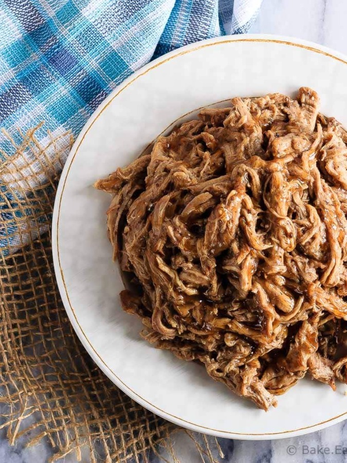 This tender maple balsamic pork tenderloin takes just minutes to get into the slow cooker and is amazing piled onto a soft roll for an easy dinner!